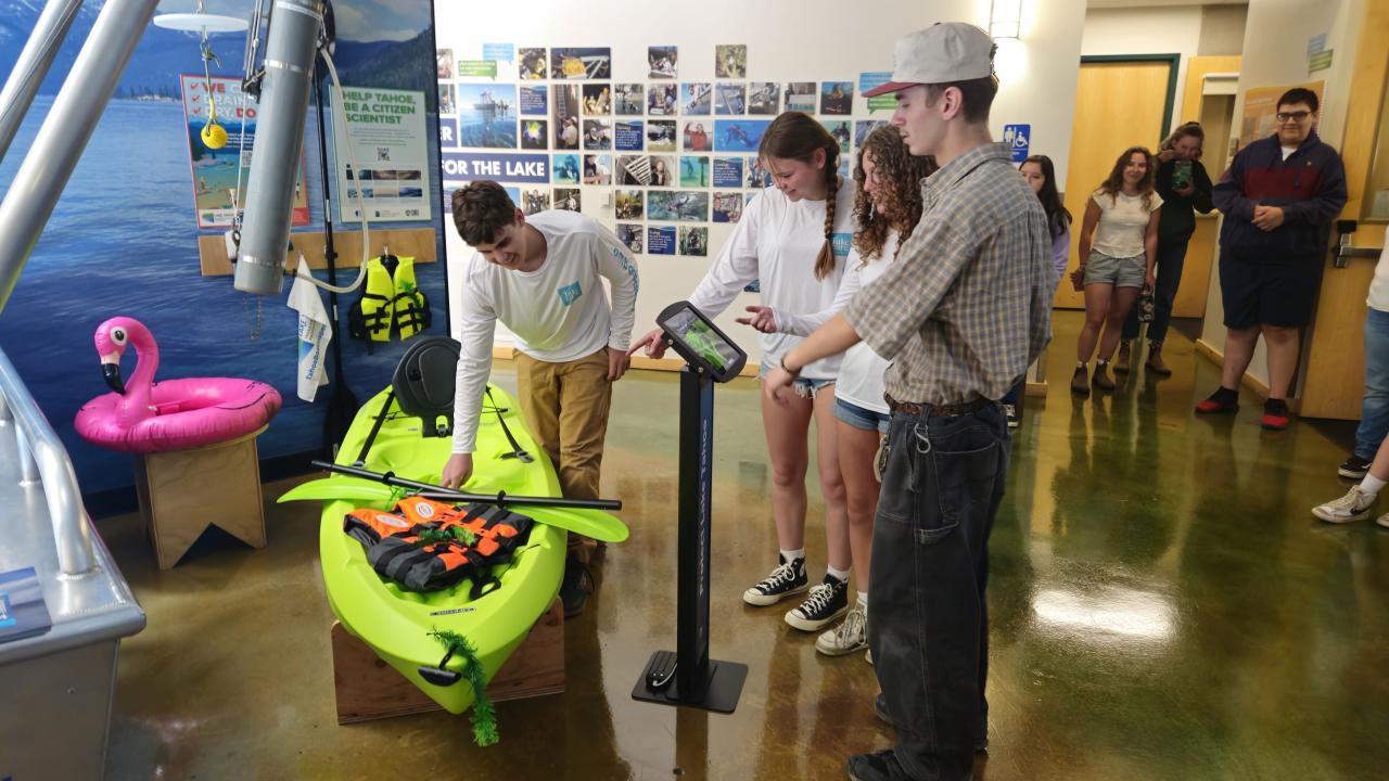 Students discover where aquatic invasives can hide on standard equipment for kayaking on the lake