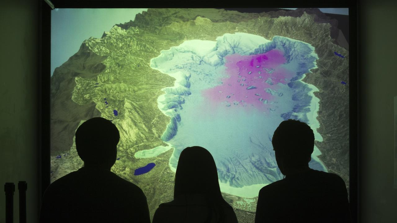 visitors (backs of head) viewing the 3d movie Lake Tahoe in Depth in background