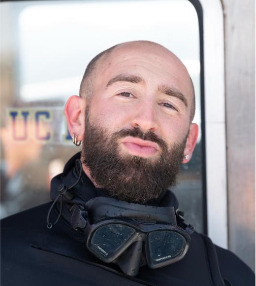 Noah in a wet suit showing his best smirk