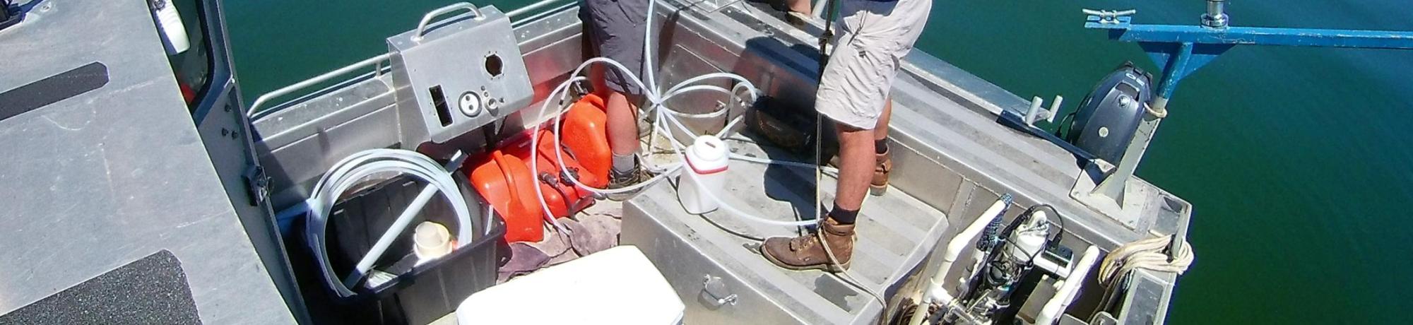 Collecting water quality sample in Clear Lake with a peristaltic pump