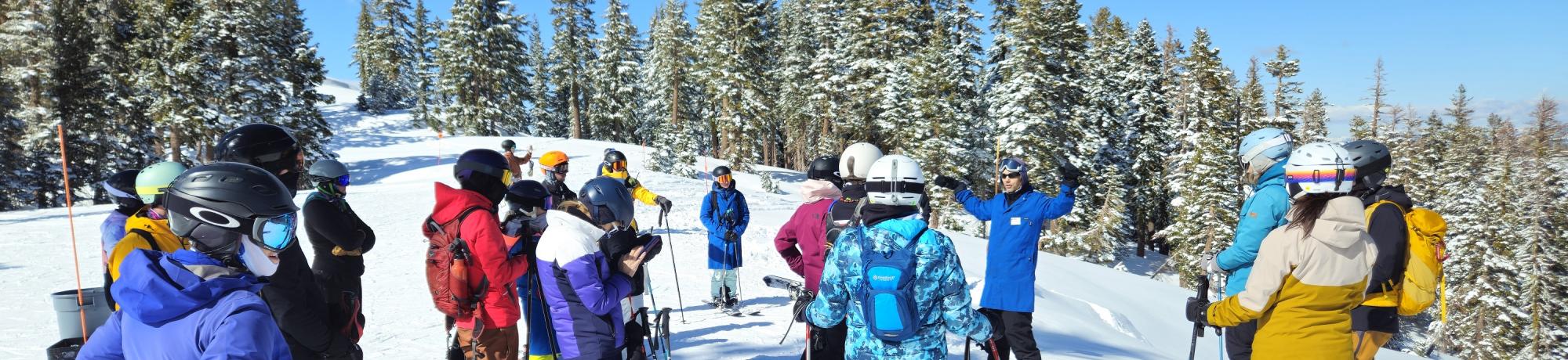 Forest Ecologist Aaron discuss restoration efforts with skiers and snowboarders at Palisades Tahoe Alpine